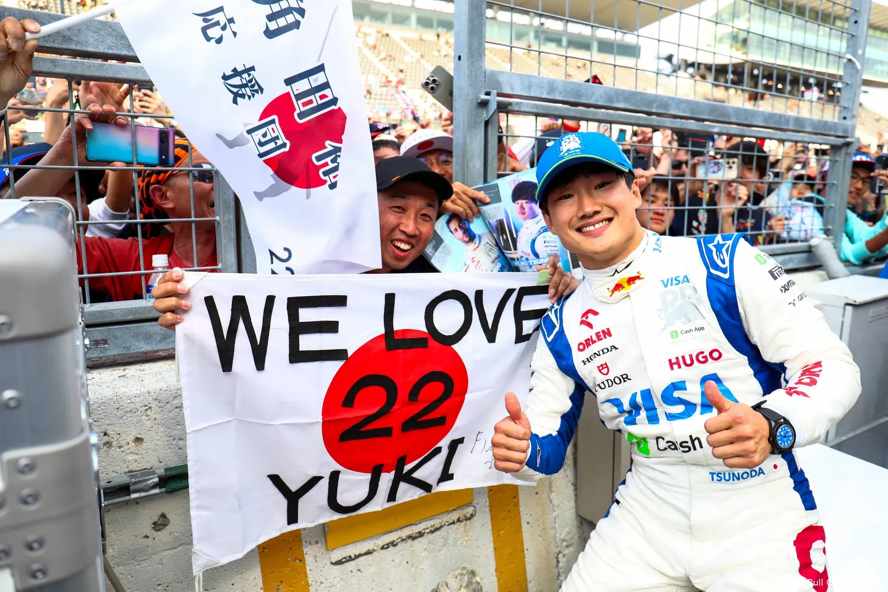 Tsunoda laughs with Verstappen and Sainz at fans in Japan